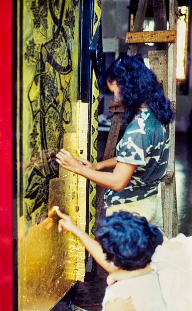 Applying Gold Leaf to Make Merit, Bangkok, Thailand